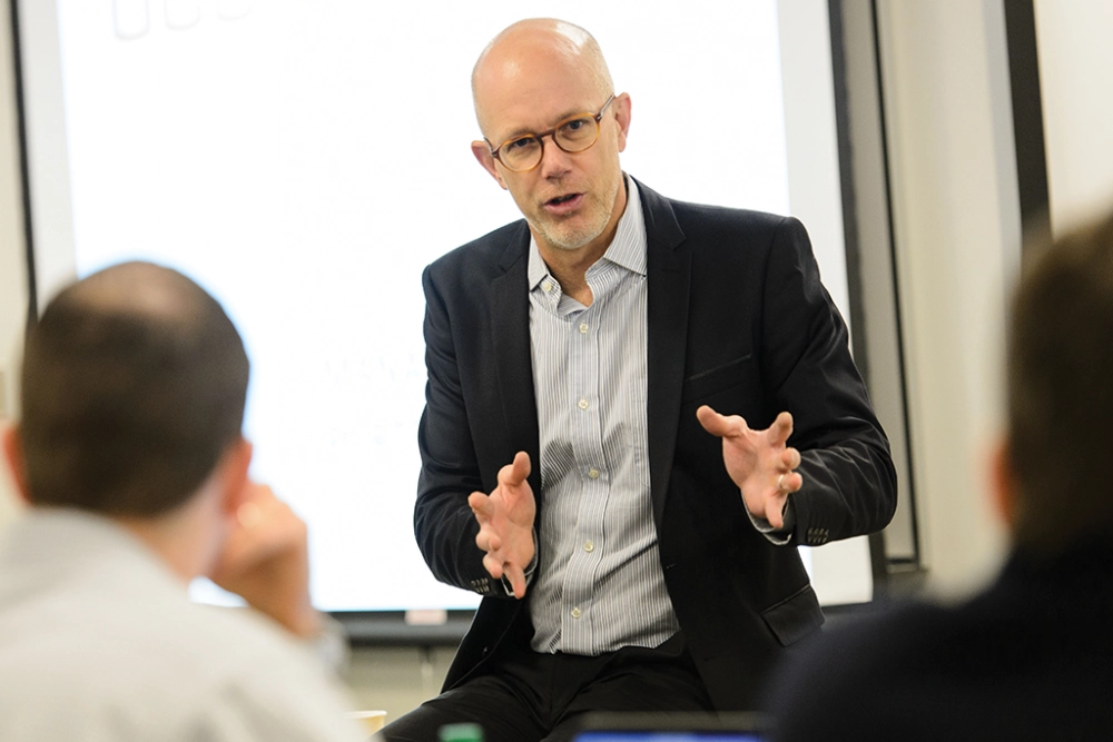 EMBA faculty member lecturing to students