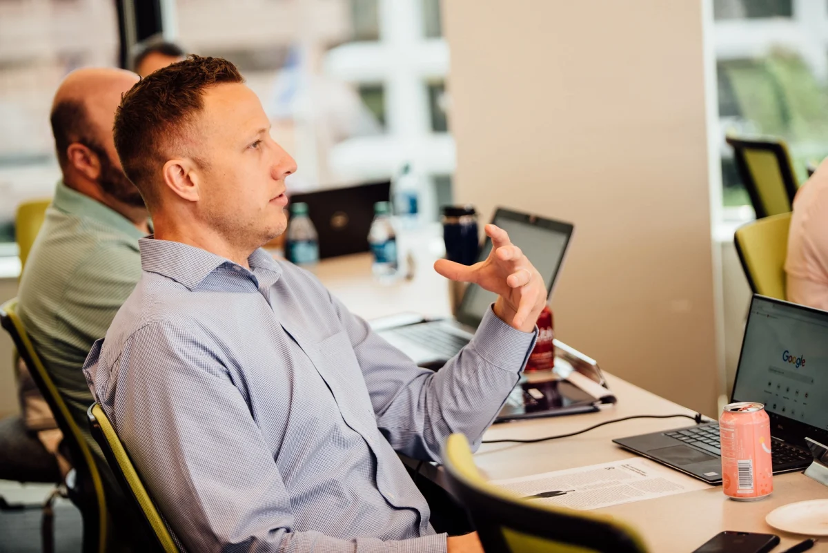 UConn's Business Analytics and Project Managment students posing for photo in front of sculpture.